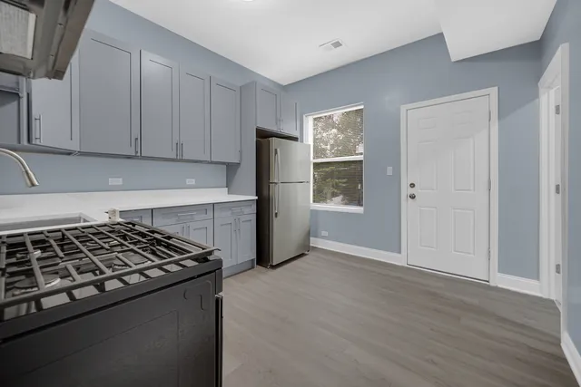 a kitchen with granite countertop a stove and a refrigerator
