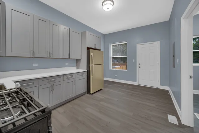 a kitchen with wooden cabinets and a stove top oven