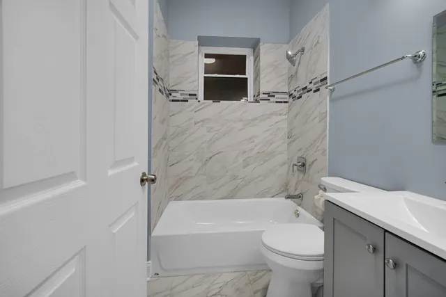 a bathroom with a toilet and a bathtub