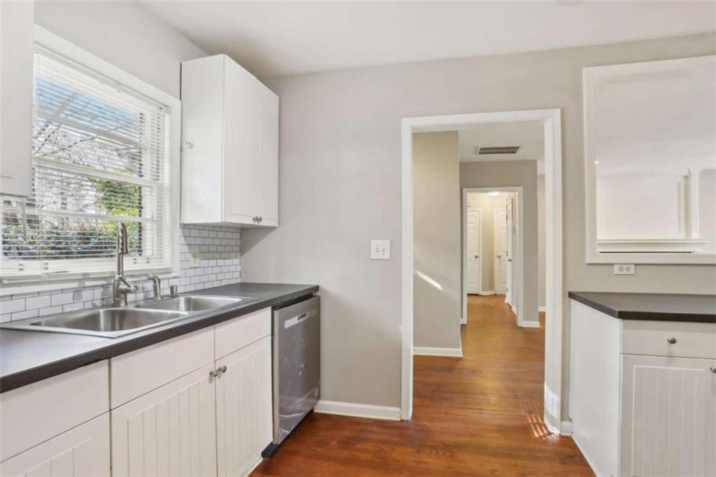 1840 Camellia Drive Decatur, GA 30032 - Photo 12 of 28 a kitchen with granite countertop a sink and a wooden floor