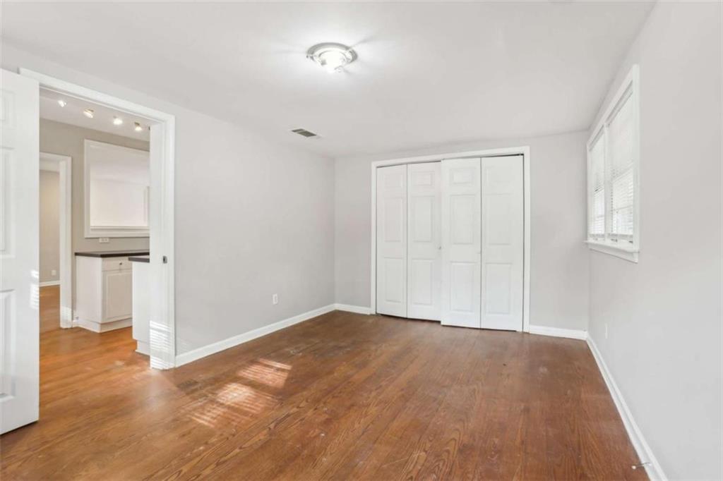1840 Camellia Drive Decatur, GA 30032 - Photo 18 of 28 a view of an empty room with wooden floor and a window