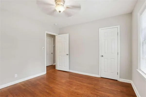 a view of an empty room with wooden floor