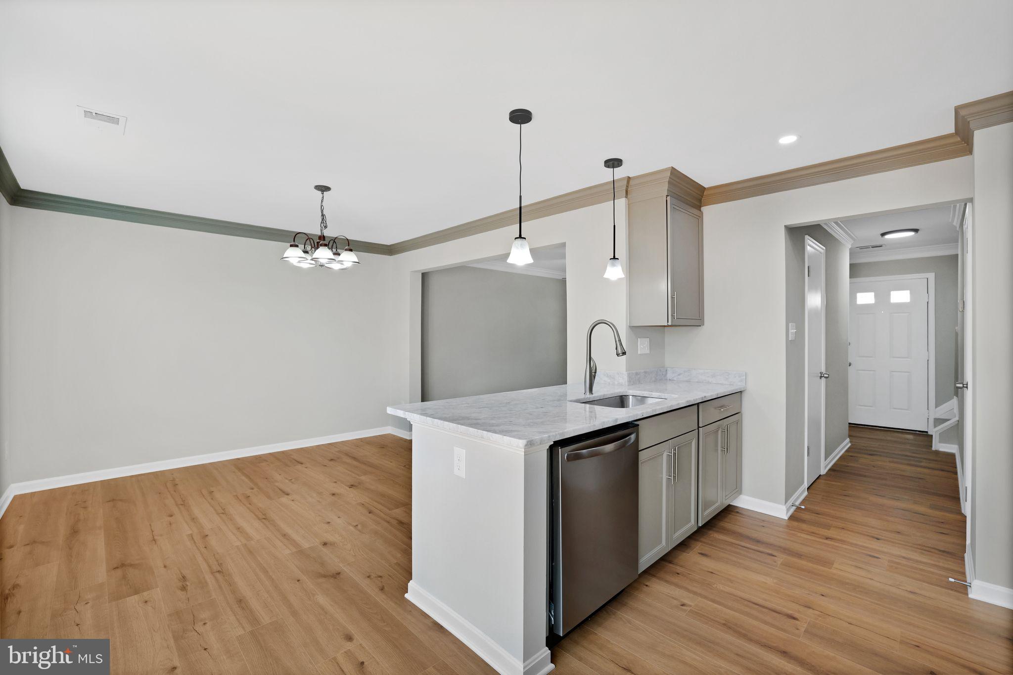 815 Cedar Court La Plata, MD 20646 - Photo 12 of 43 a kitchen with stainless steel appliances granite countertop a sink and a wooden floor