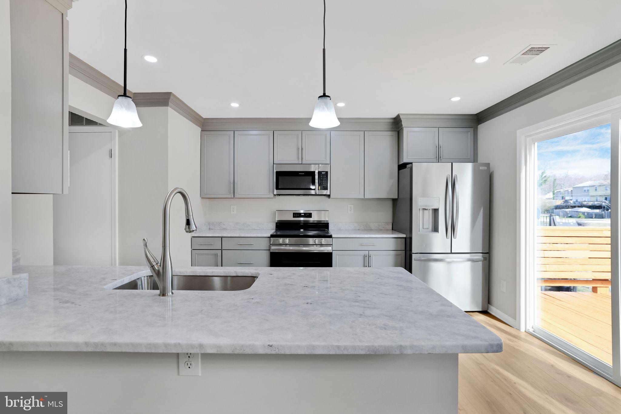 815 Cedar Court La Plata, MD 20646 - Photo 13 of 43 a kitchen with kitchen island a counter space a sink appliances and cabinets