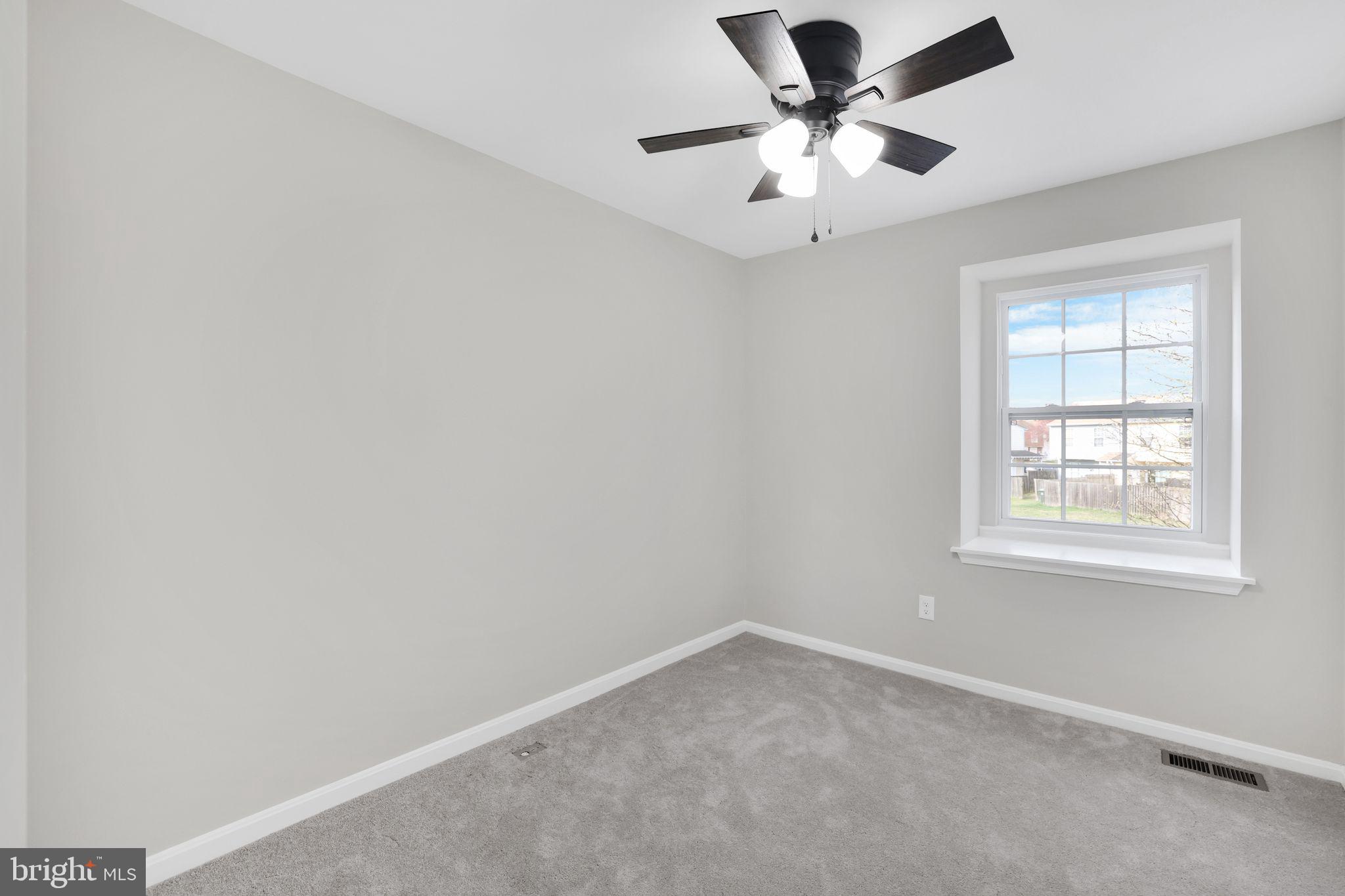 815 Cedar Court La Plata, MD 20646 - Photo 21 of 43 an empty room with a chandelier fan and windows