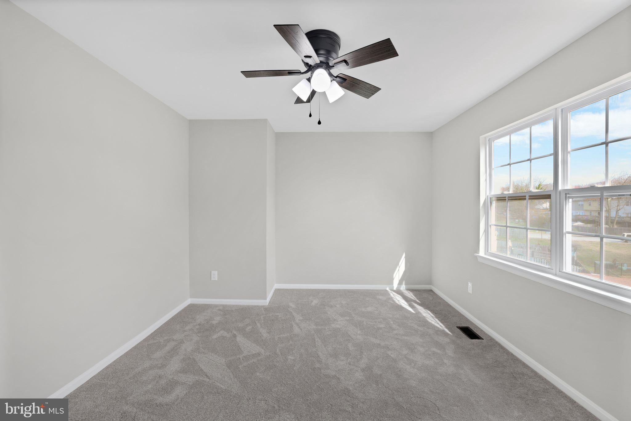 815 Cedar Court La Plata, MD 20646 - Photo 26 of 43 an empty room with ceiling fan and window