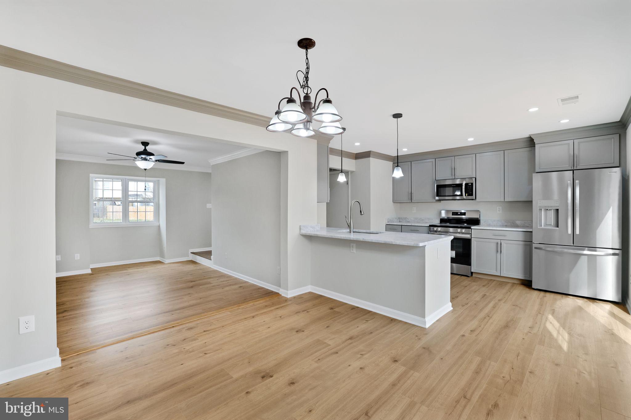 815 Cedar Court La Plata, MD 20646 - Photo 3 of 43 a kitchen with granite countertop a refrigerator a sink dishwasher a stove and white cabinets with wooden floor