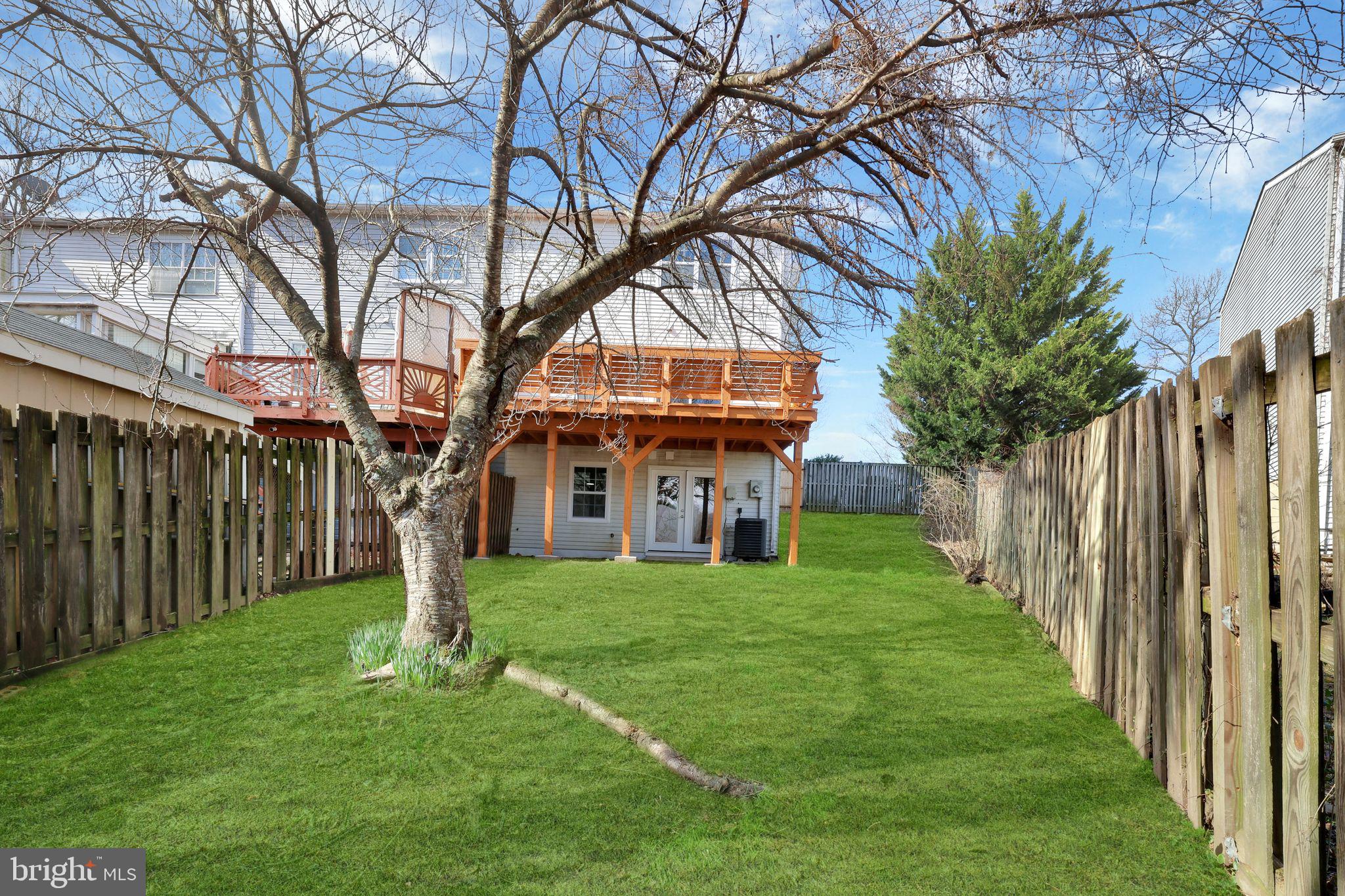 815 Cedar Court La Plata, MD 20646 - Photo 41 of 43 a yellow house with a big yard and large trees