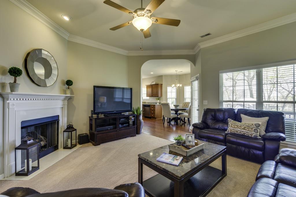 1056 Golf View Way Spring Hill, TN 37174 - Photo 8 of 29 a living room with furniture a fireplace and a chandelier