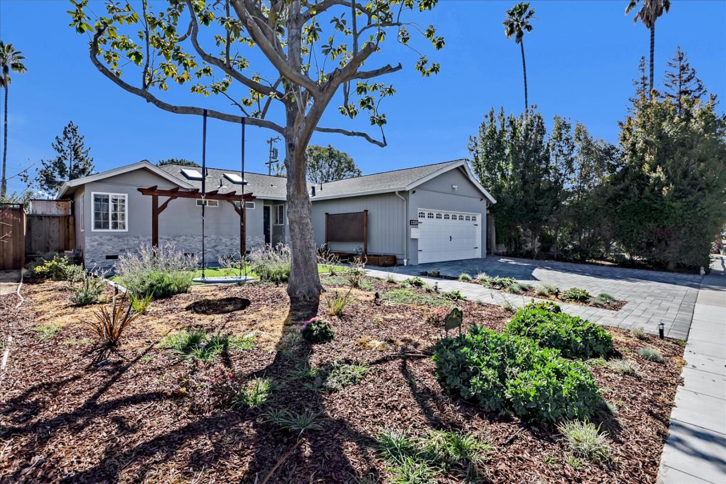 1220 Redcliff Drive San Jose, CA 95118 - Photo 2 of 39 a front view of a house with garden
