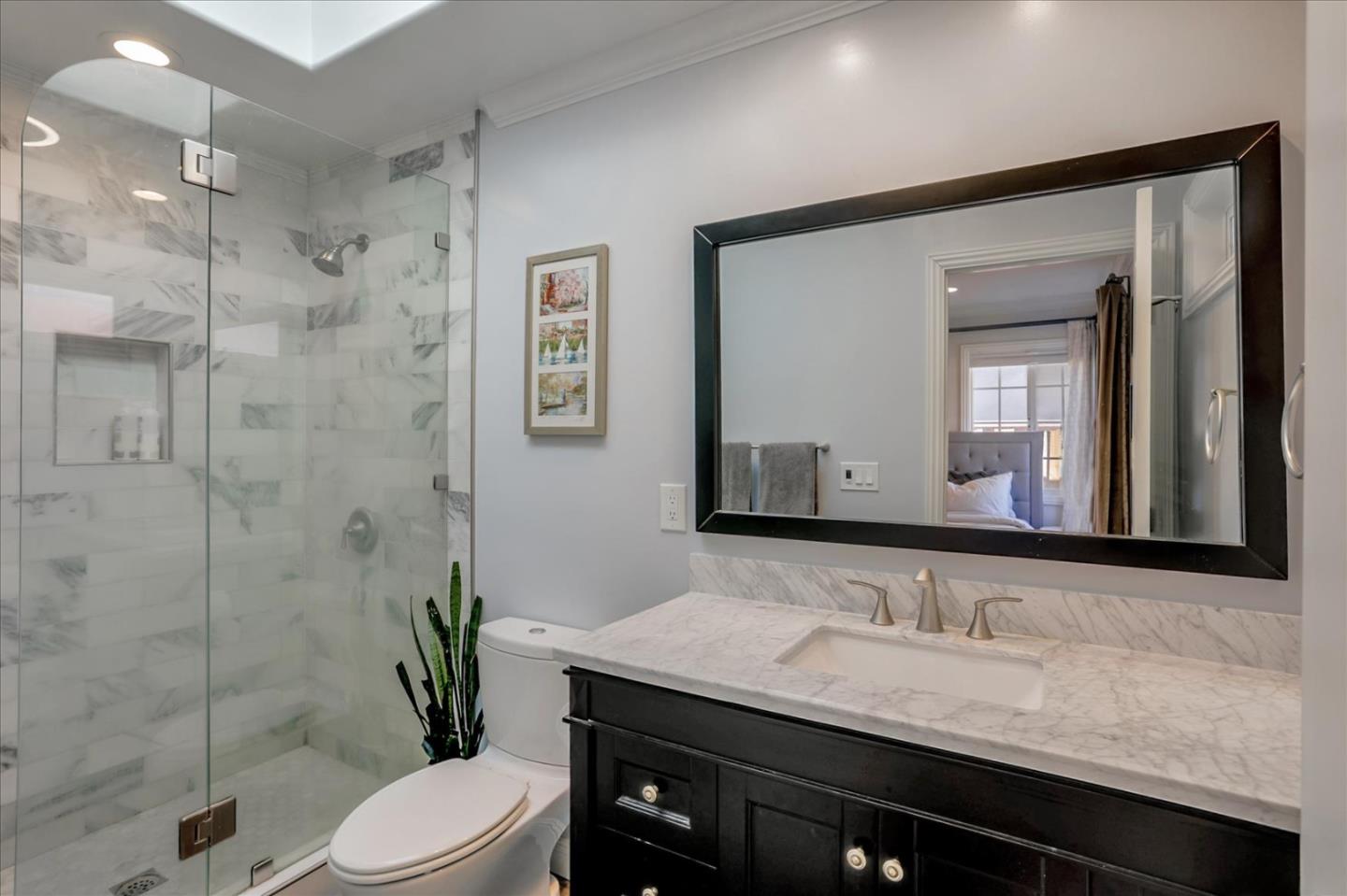 1220 Redcliff Drive San Jose, CA 95118 - Photo 29 of 39 a bathroom with a granite countertop sink toilet a mirror a vanity and shower