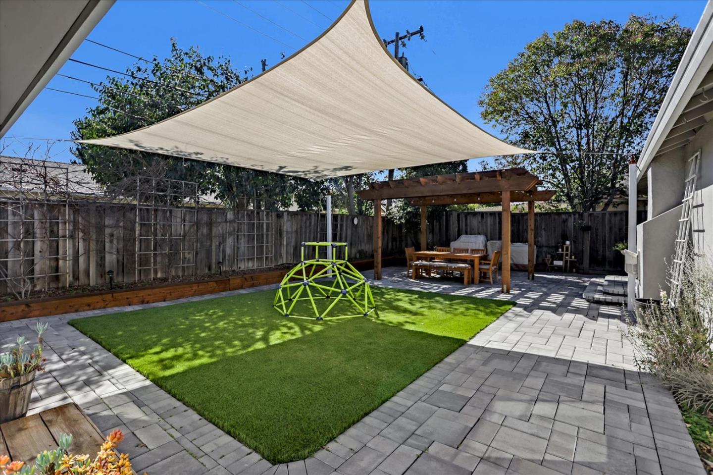 1220 Redcliff Drive San Jose, CA 95118 - Photo 37 of 39 a view of a backyard with table and chairs under an umbrella