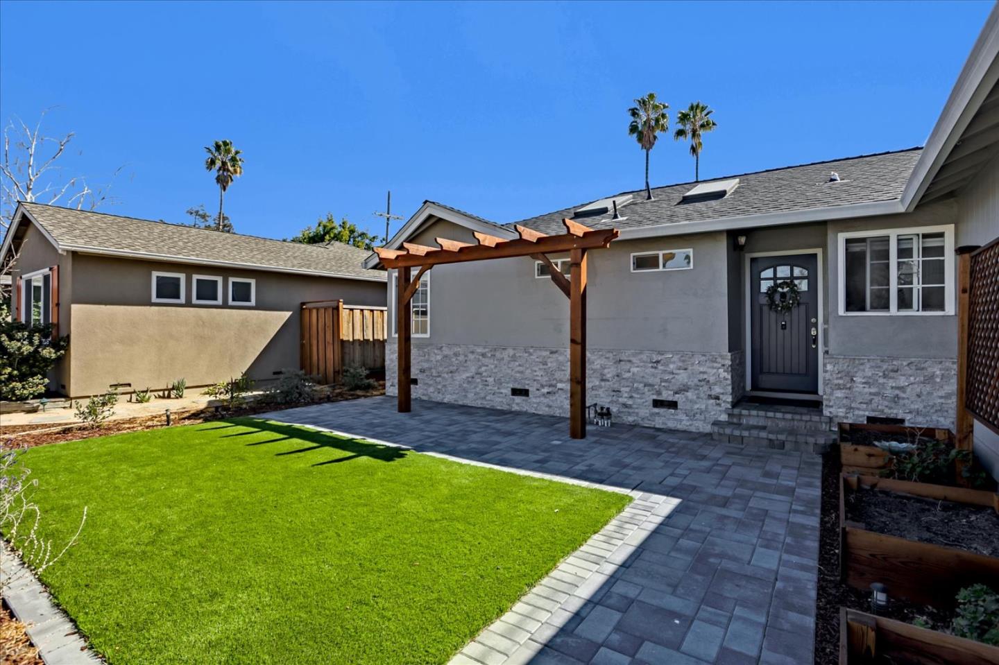 1220 Redcliff Drive San Jose, CA 95118 - Photo 5 of 39 a front view of a house with a garden