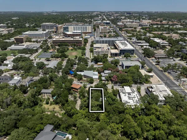 an aerial view of residential houses with city view