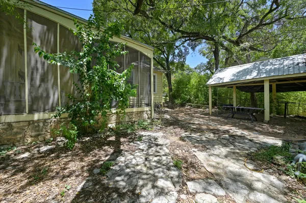 a view of a house with a small yard and plants