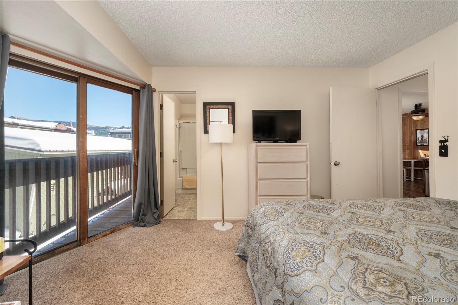 490 Kings Crossing Road, Unit 321 Winter Park, CO 80482 - Photo 11 of 46 a bedroom with a bed and a flat screen tv