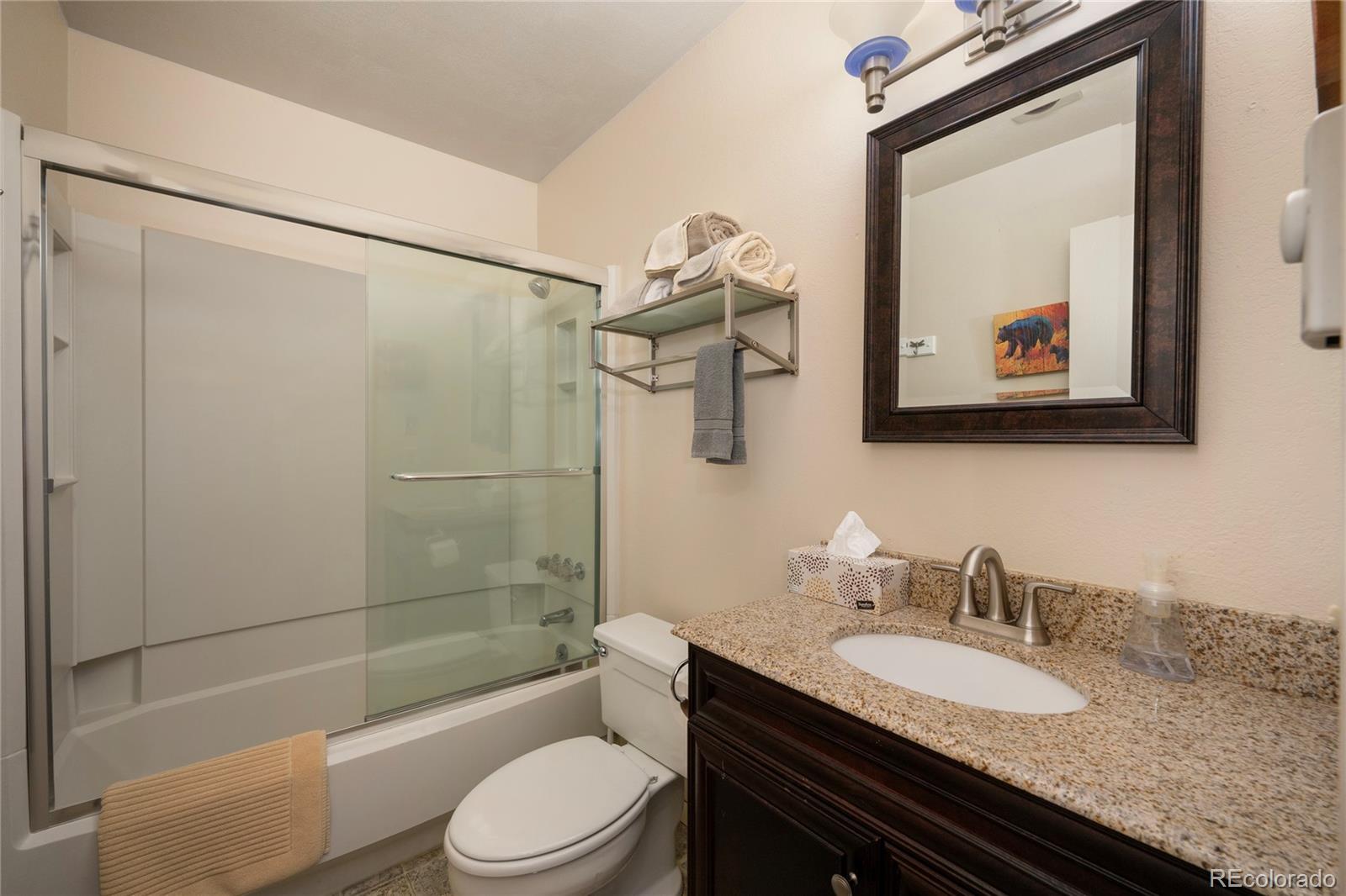 490 Kings Crossing Road, Unit 321 Winter Park, CO 80482 - Photo 14 of 46 a bathroom with a granite countertop sink toilet and shower