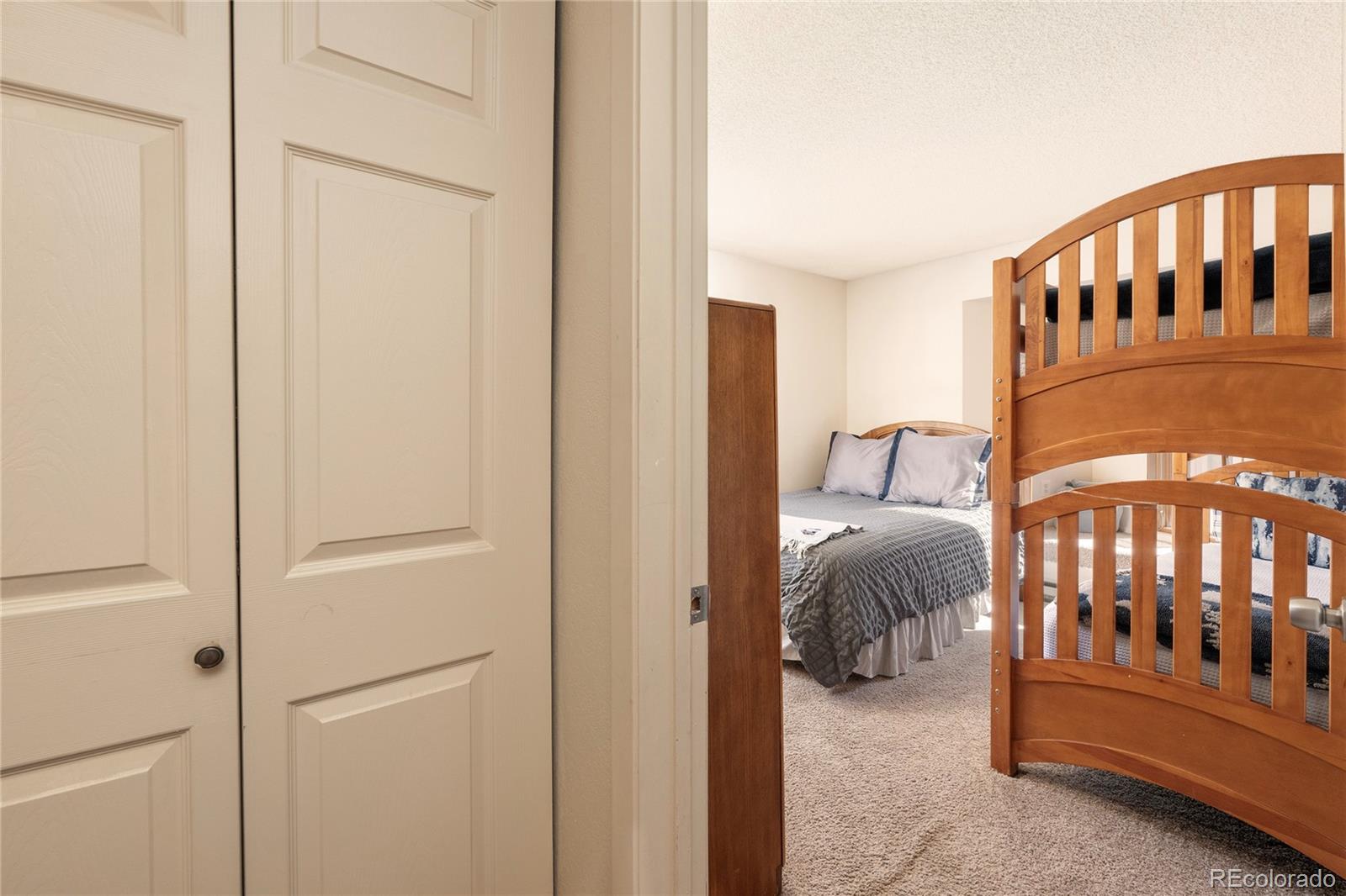 490 Kings Crossing Road, Unit 321 Winter Park, CO 80482 - Photo 17 of 46 a bedroom with furniture and baby crib