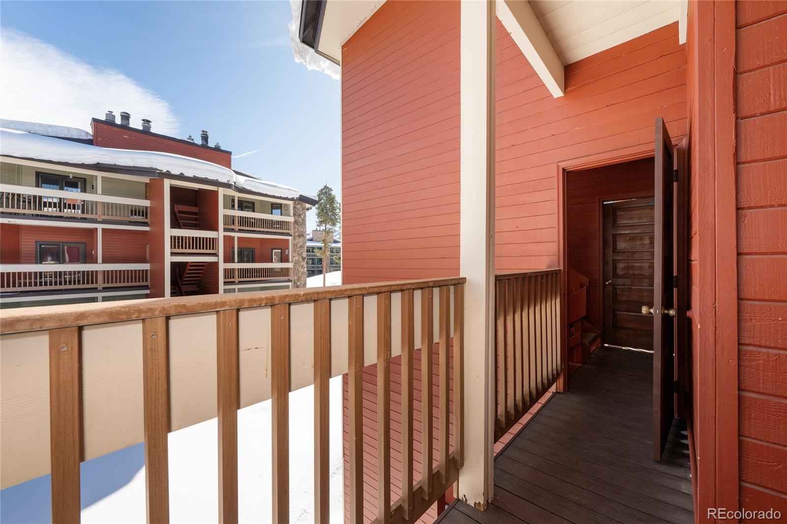 490 Kings Crossing Road, Unit 321 Winter Park, CO 80482 - Photo 22 of 46 a view of a balcony with wooden floor and fence