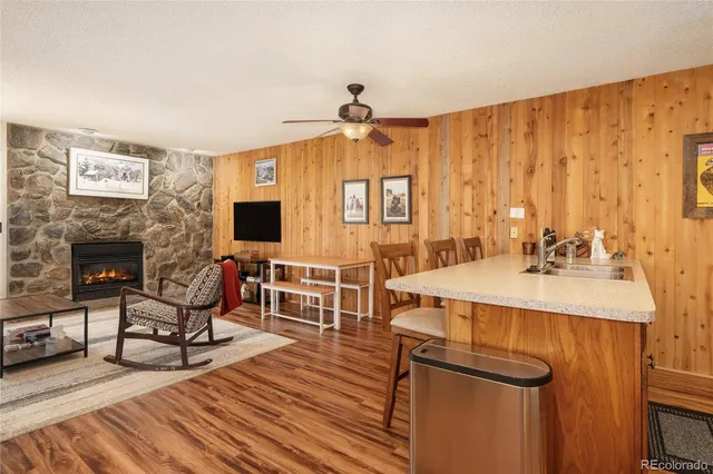 a living room with furniture a flat screen tv and a fireplace