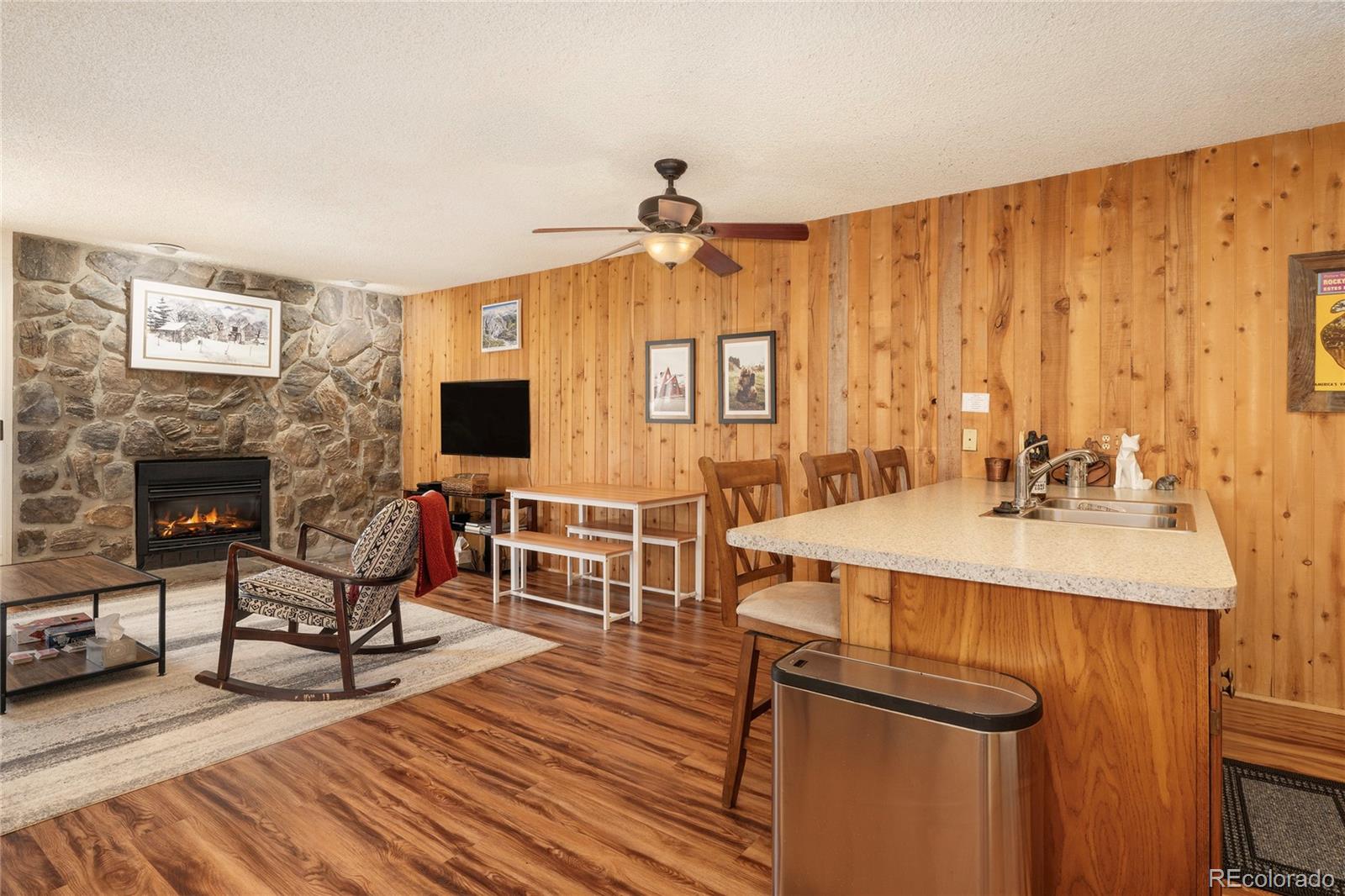 490 Kings Crossing Road, Unit 321 Winter Park, CO 80482 - Photo 3 of 46 a living room with furniture a flat screen tv and a fireplace