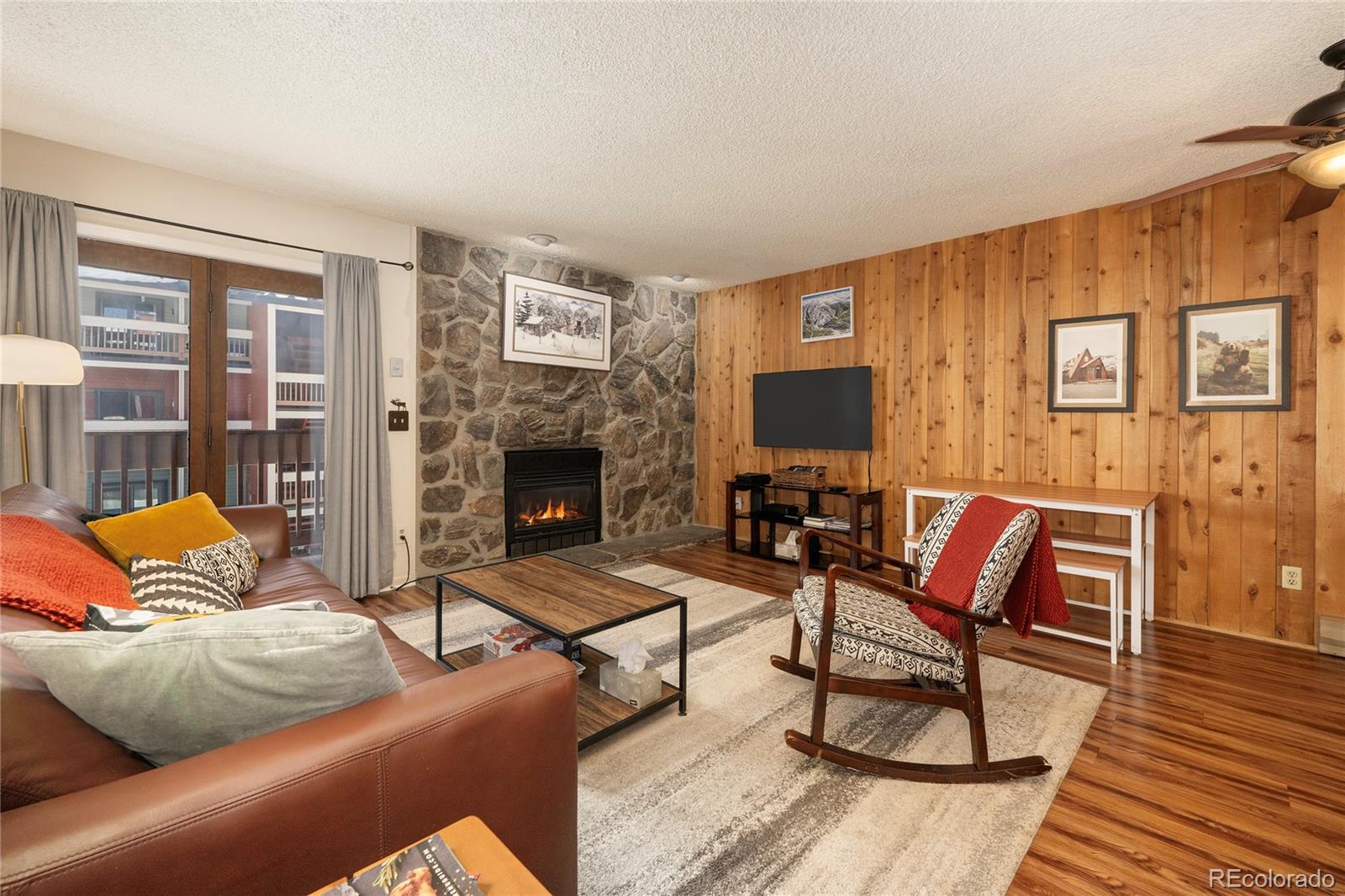 490 Kings Crossing Road, Unit 321 Winter Park, CO 80482 - Photo 6 of 46 a living room with furniture and a fireplace