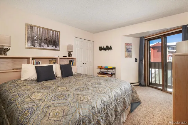 a bedroom with a large bed and a large window