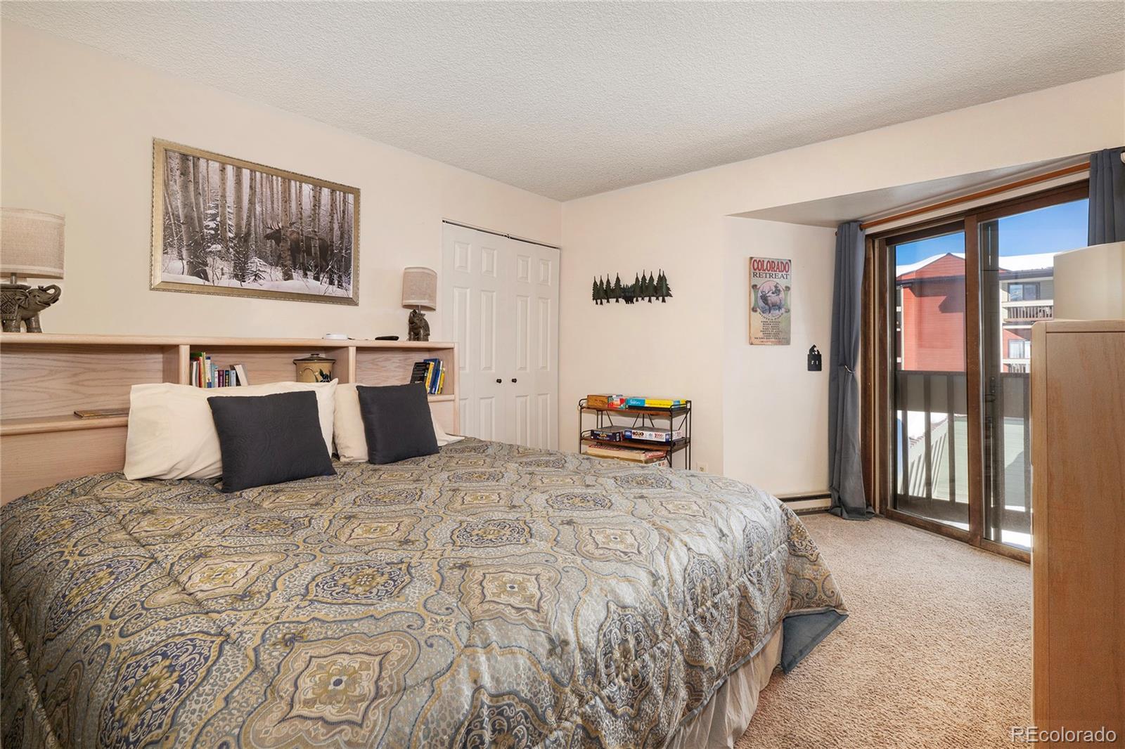 490 Kings Crossing Road, Unit 321 Winter Park, CO 80482 - Photo 10 of 46 a bedroom with a large bed and a large window