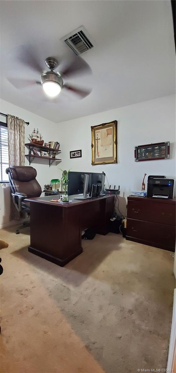 14140 Southwest 275th Street, Unit 1 Homestead, FL 33032 - Photo 17 of 25 a living room with furniture and a flat screen tv