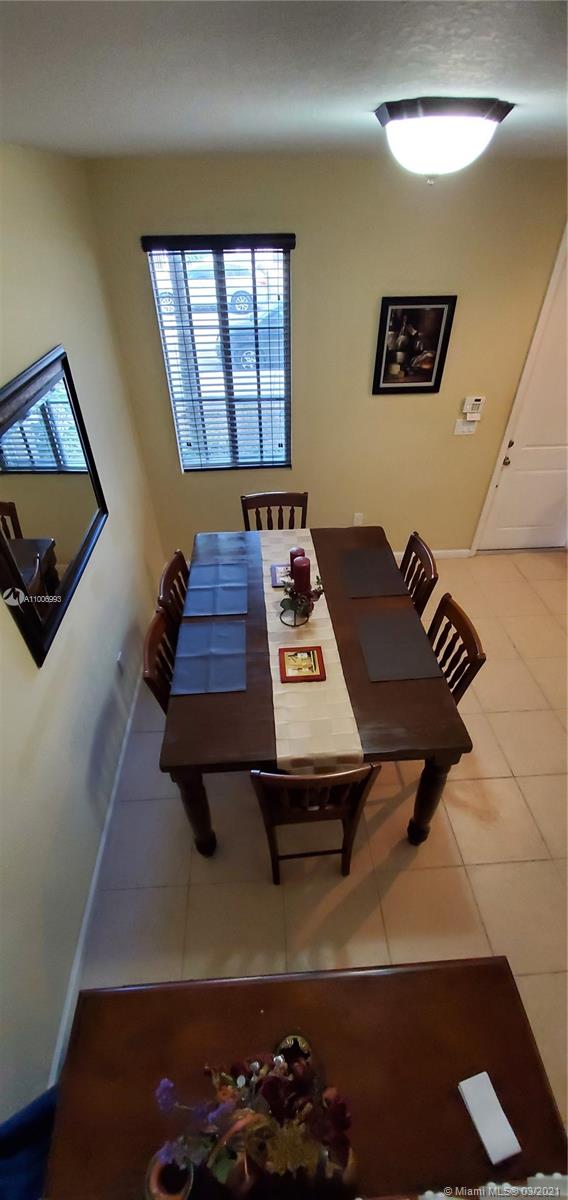 14140 Southwest 275th Street, Unit 1 Homestead, FL 33032 - Photo 19 of 25 a bedroom with a bed and a window