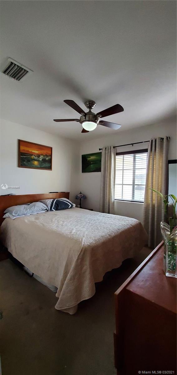 14140 Southwest 275th Street, Unit 1 Homestead, FL 33032 - Photo 21 of 25 a bedroom with a bed and window