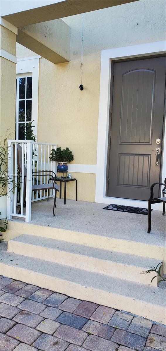 14140 Southwest 275th Street, Unit 1 Homestead, FL 33032 - Photo 6 of 25 a view of a patio with table and chairs
