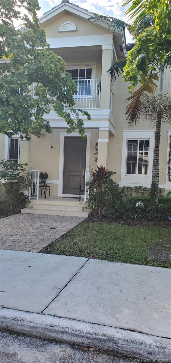14140 Southwest 275th Street, Unit 1 Homestead, FL 33032 - Photo 7 of 25 a front view of a house with garden