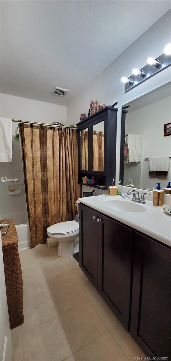 14140 Southwest 275th Street, Unit 1 Homestead, FL 33032 - Photo 9 of 25 a bathroom with a double vanity sink and a mirror
