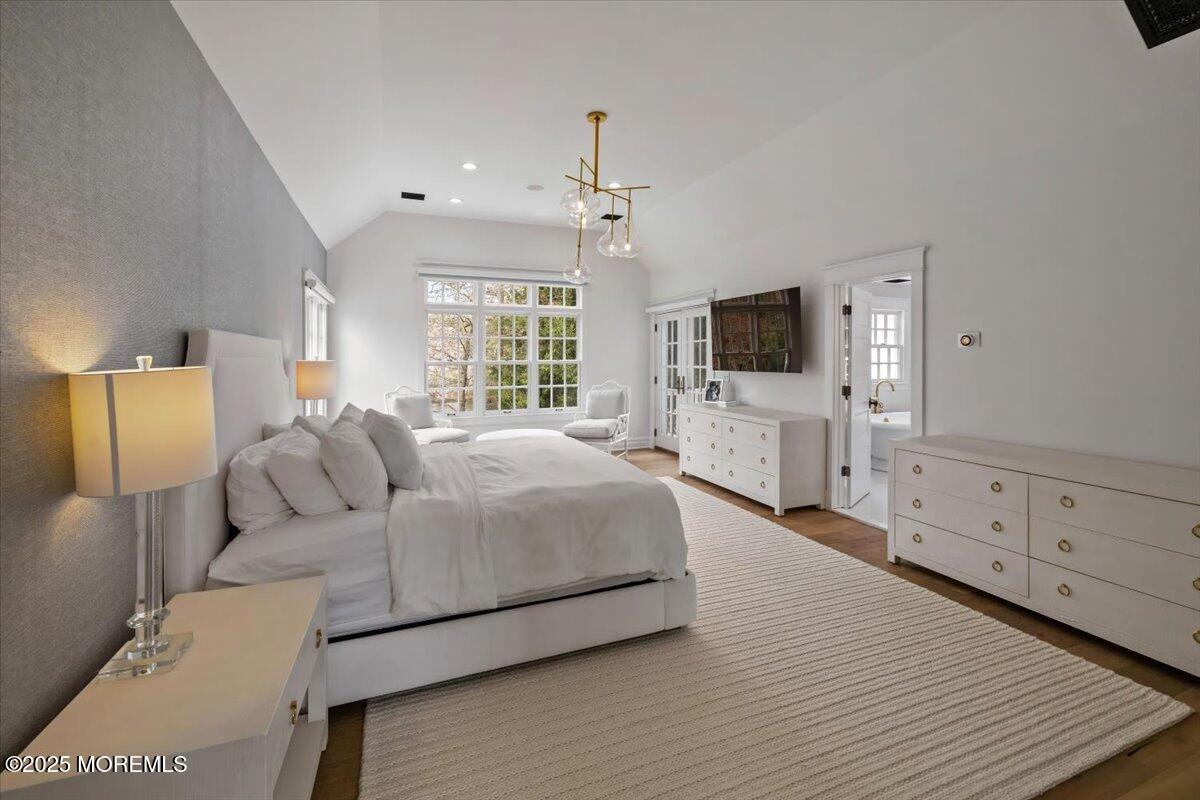 4 Broadmoor Drive Rumson, NJ 07760 - Photo 21 of 52 a spacious bedroom with a bed and a flat tv screen on dresser