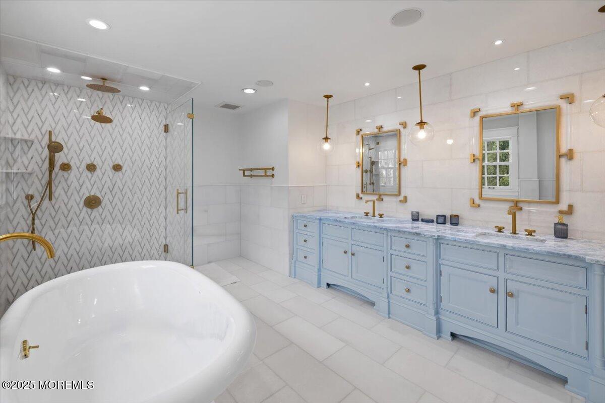 4 Broadmoor Drive Rumson, NJ 07760 - Photo 23 of 52 a bathroom with a granite countertop sink a large mirror and shower