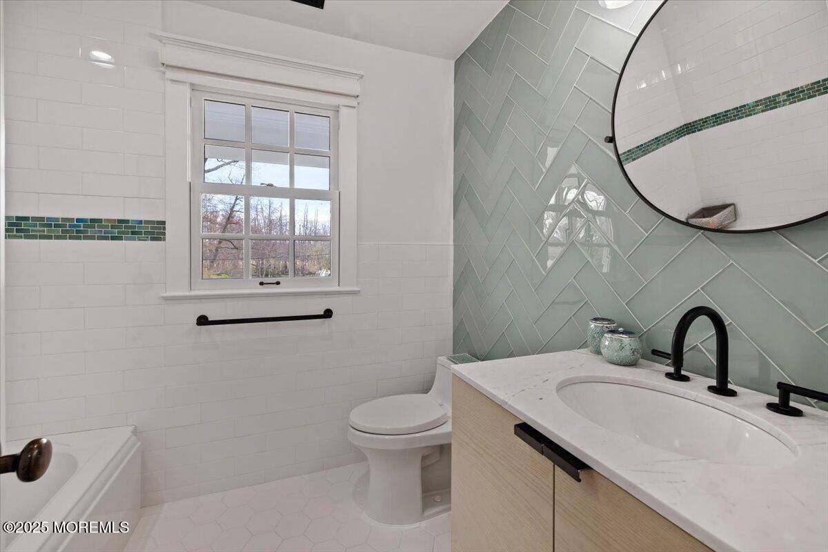 4 Broadmoor Drive Rumson, NJ 07760 - Photo 26 of 52 a bathroom with a sink a toilet and a mirror