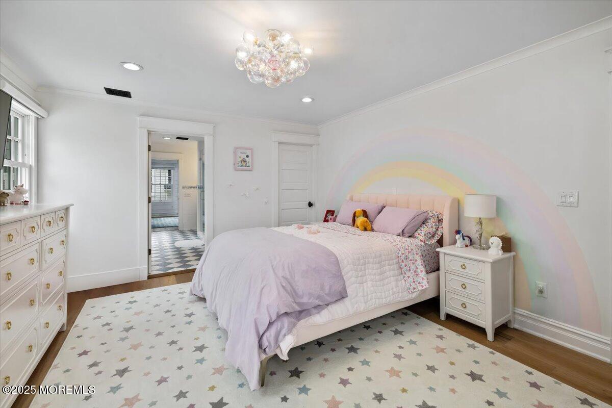 4 Broadmoor Drive Rumson, NJ 07760 - Photo 27 of 52 a bedroom with a bed and a chandelier