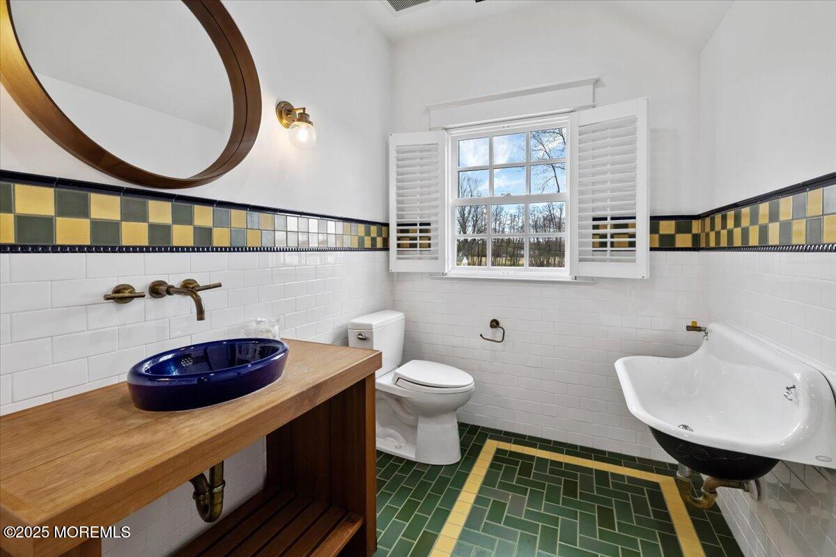 4 Broadmoor Drive Rumson, NJ 07760 - Photo 37 of 52 a bathroom with a sink a mirror and a toilet