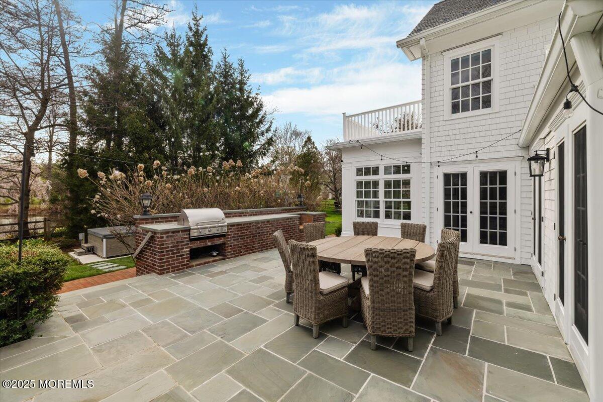 4 Broadmoor Drive Rumson, NJ 07760 - Photo 39 of 52 a view of a patio with table and chairs
