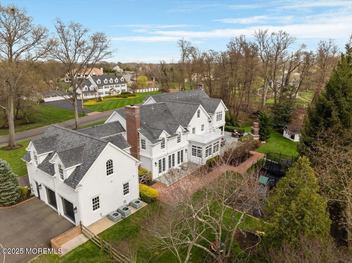 4 Broadmoor Drive Rumson, NJ 07760 - Photo 46 of 52 a view of a white house with a yard and sitting area