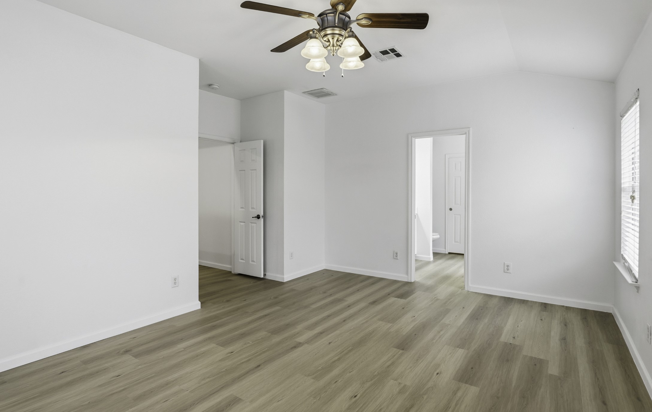 814 Bogart Road Cedar Park, TX 78613 - Photo 15 of 25 an empty room with wooden floor fan and windows