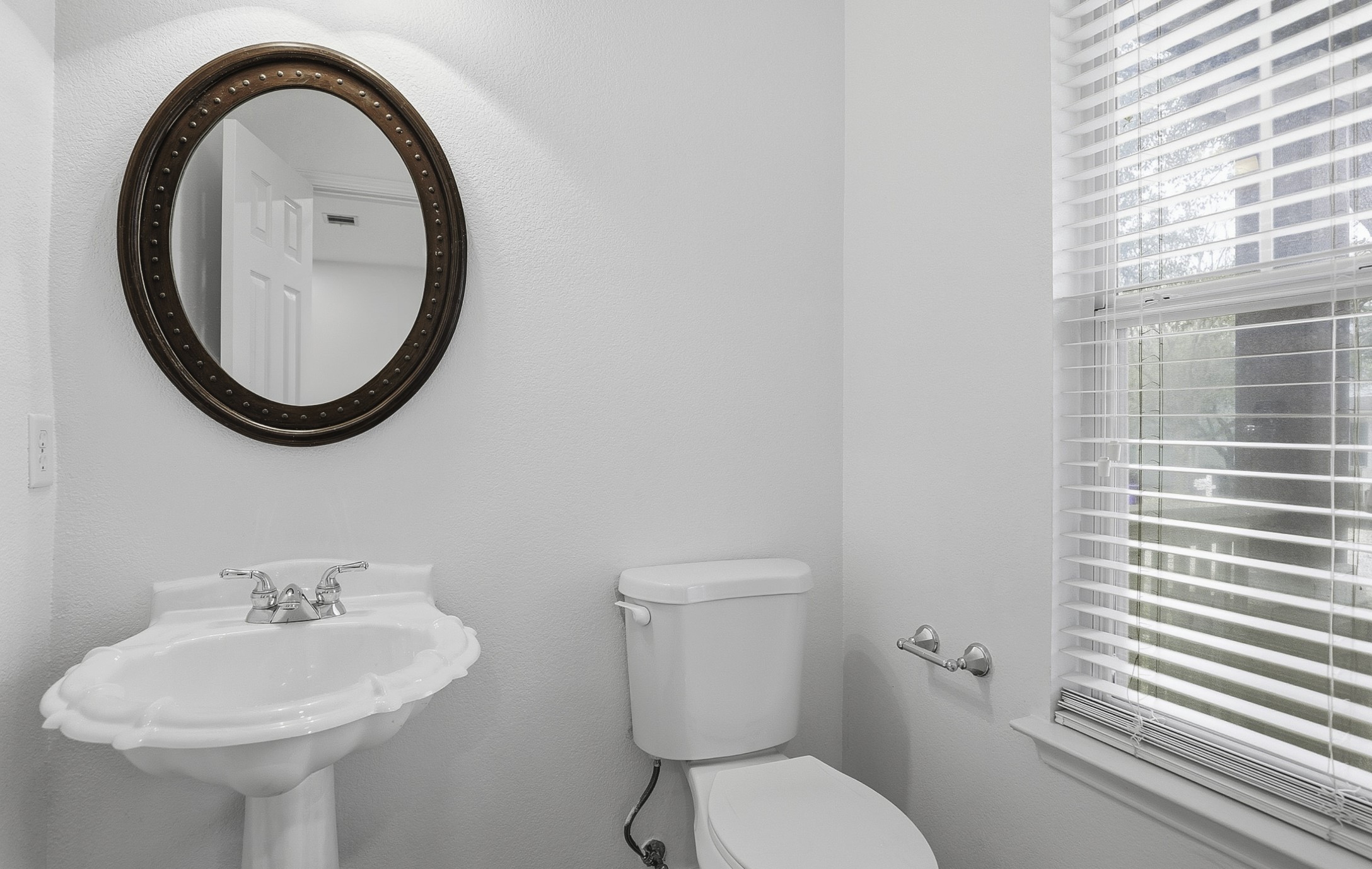 814 Bogart Road Cedar Park, TX 78613 - Photo 22 of 25 a bathroom with a toilet a sink and a mirror
