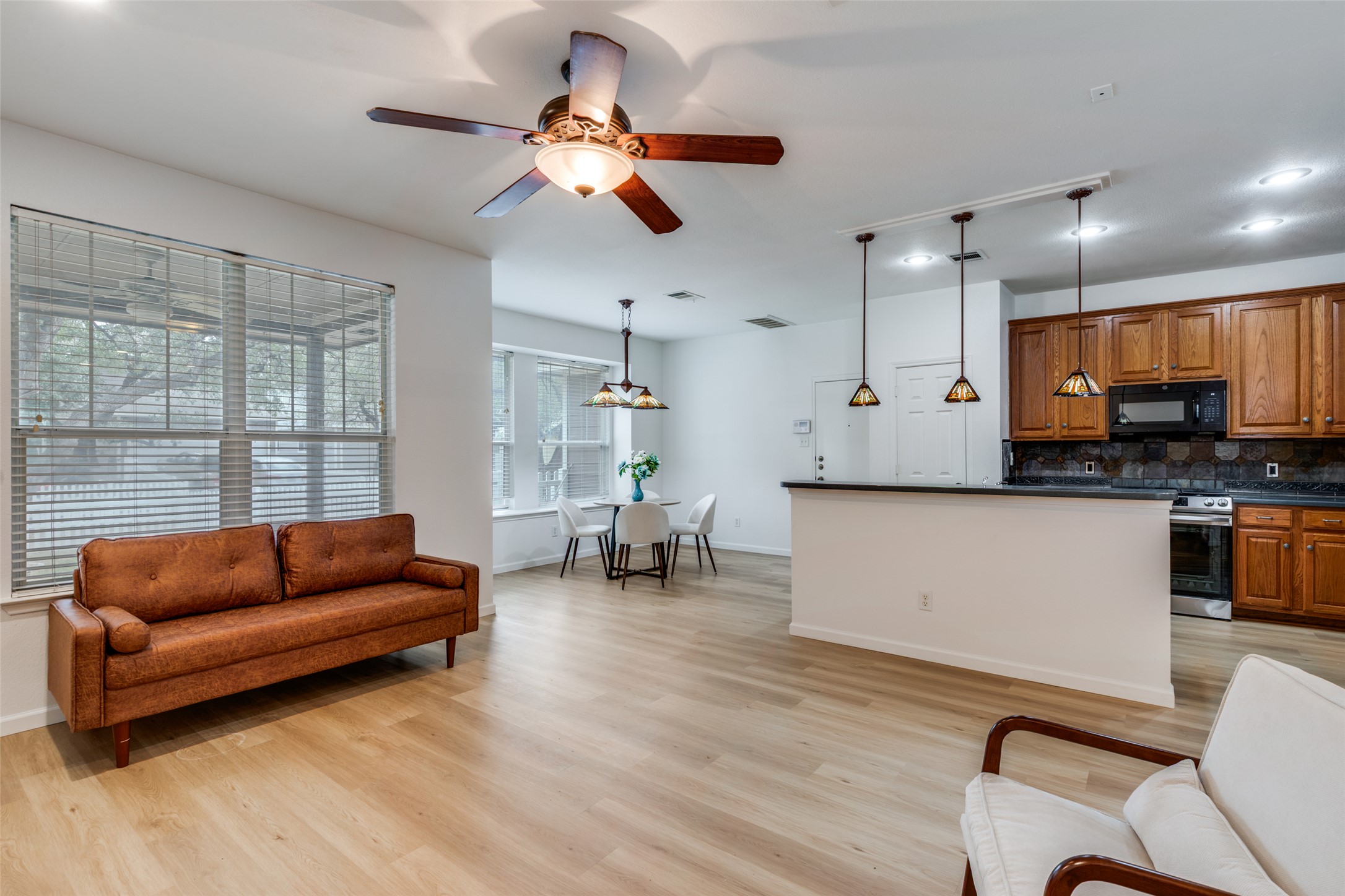 814 Bogart Road Cedar Park, TX 78613 - Photo 5 of 25 a living room with furniture kitchen view and a chandelier