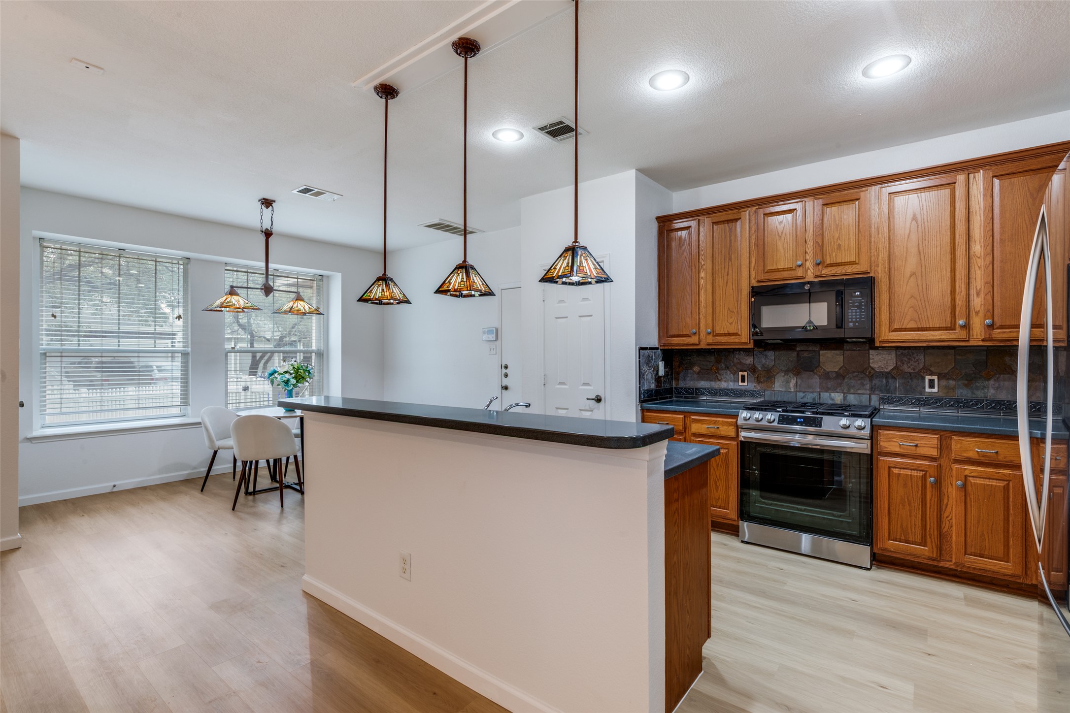 814 Bogart Road Cedar Park, TX 78613 - Photo 7 of 25 a kitchen with a sink stove and microwave