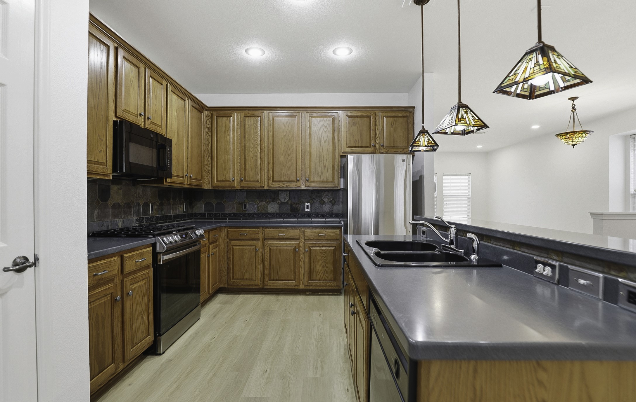 814 Bogart Road Cedar Park, TX 78613 - Photo 8 of 25 a kitchen with stainless steel appliances granite countertop a sink a stove and a refrigerator