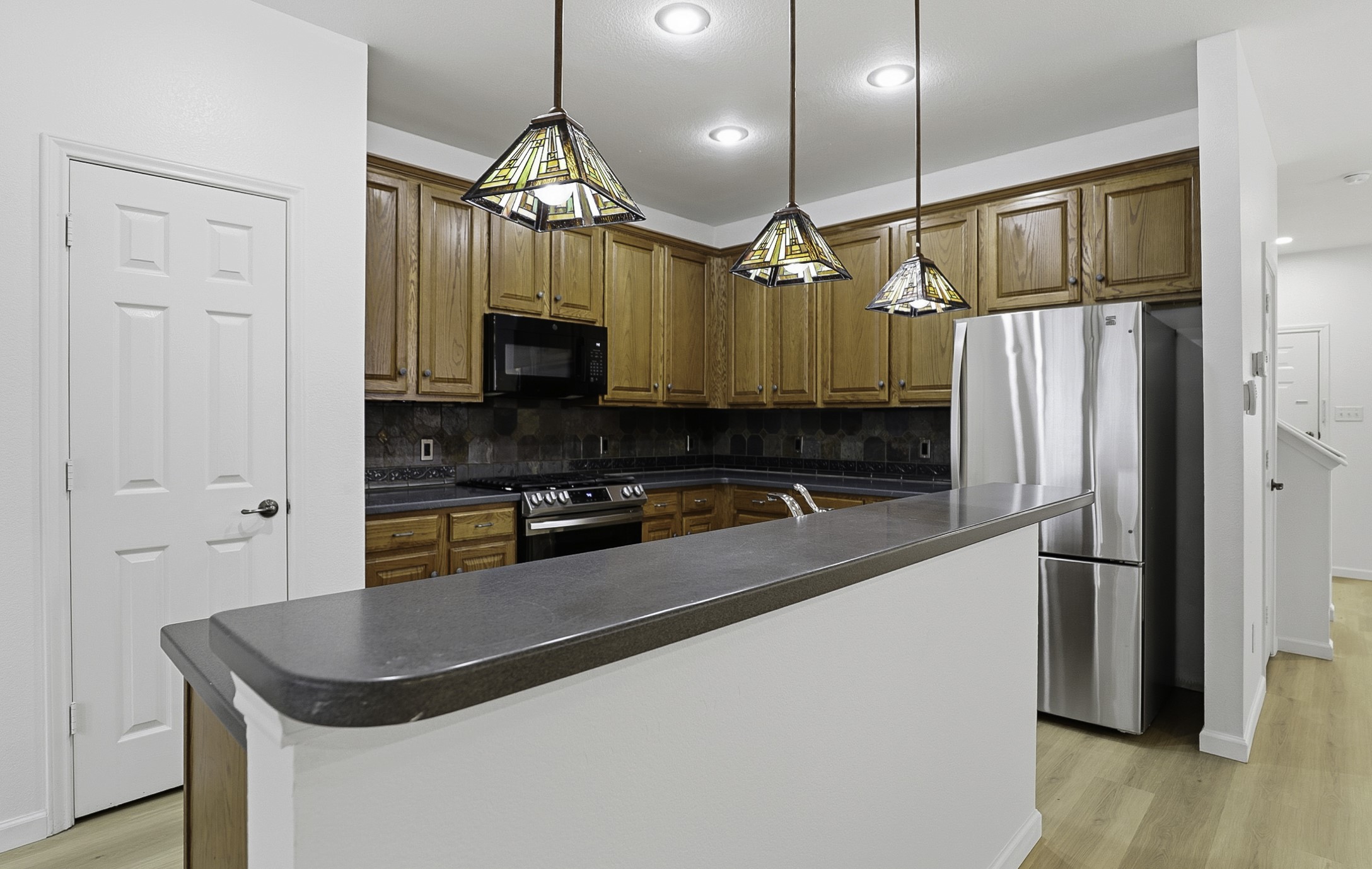 814 Bogart Road Cedar Park, TX 78613 - Photo 9 of 25 a kitchen with stainless steel appliances granite countertop a refrigerator a sink and a stove