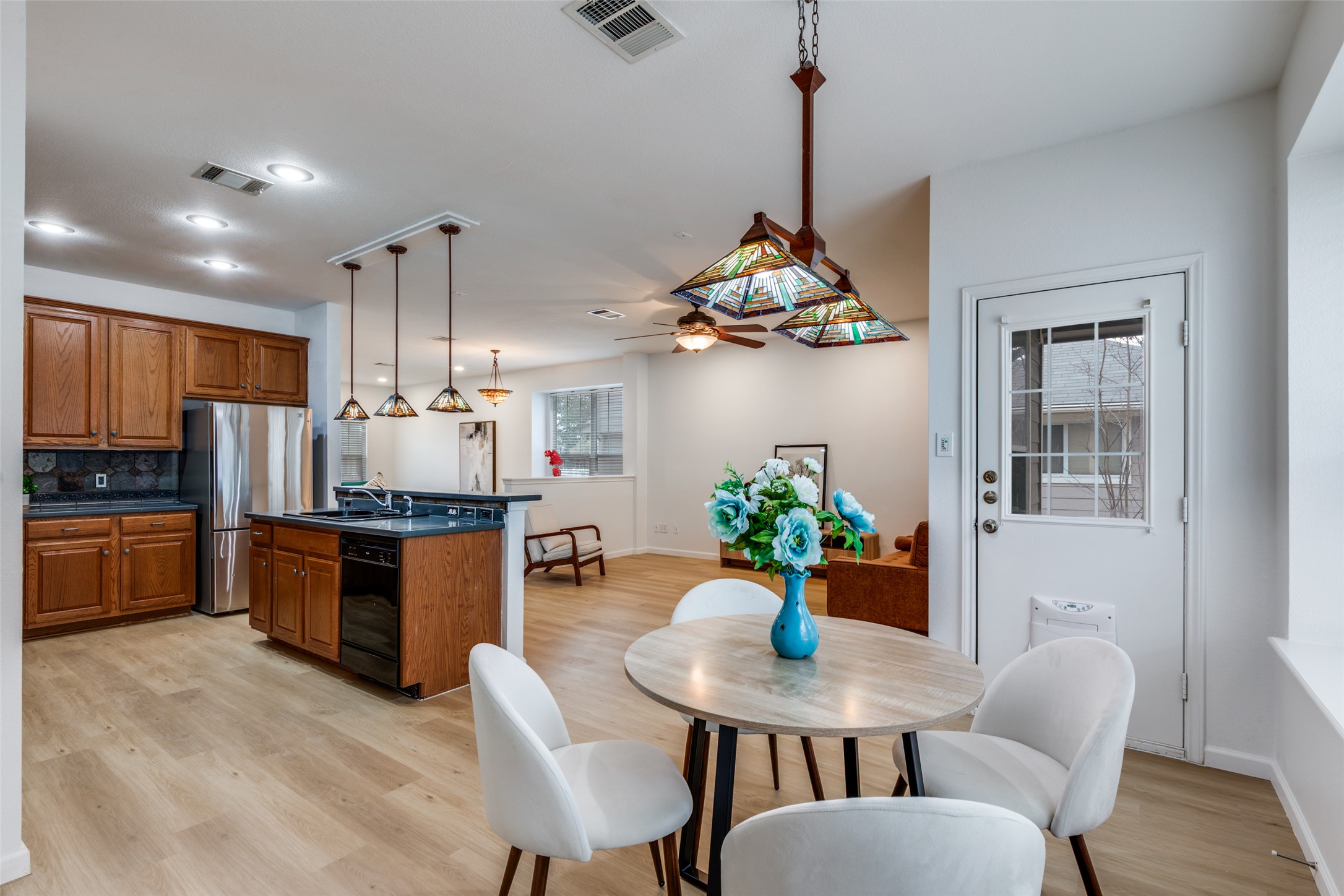 814 Bogart Road Cedar Park, TX 78613 - Photo 10 of 25 a kitchen with stainless steel appliances kitchen island granite countertop a dining table chairs and refrigerator