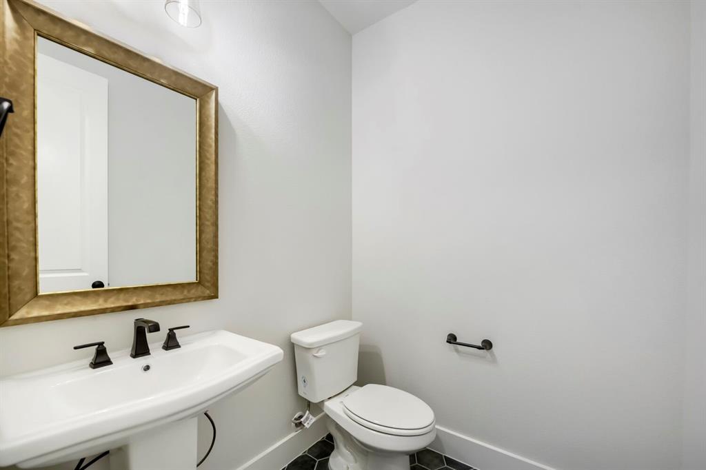 799 Mandrake Road Haslet, TX 76052 - Photo 23 of 27 a bathroom with a toilet a sink and mirror
