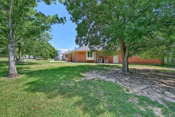 a front view of house with yard and green space